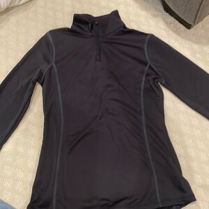 Black long-sleeved shirt with a quarter-zip neckline.
